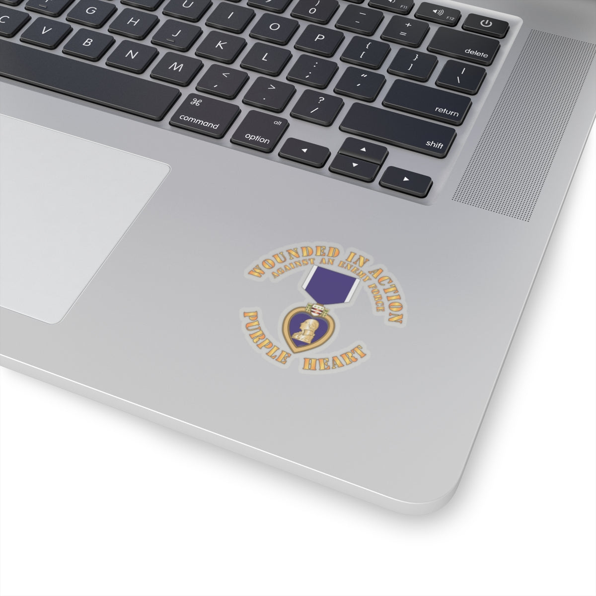 A sticker design featuring the Purple Heart medal with the text 'WOUNDED IN ACTION AGAINST AN ENEMY FORCE' and 'PURPLE HEART'.
