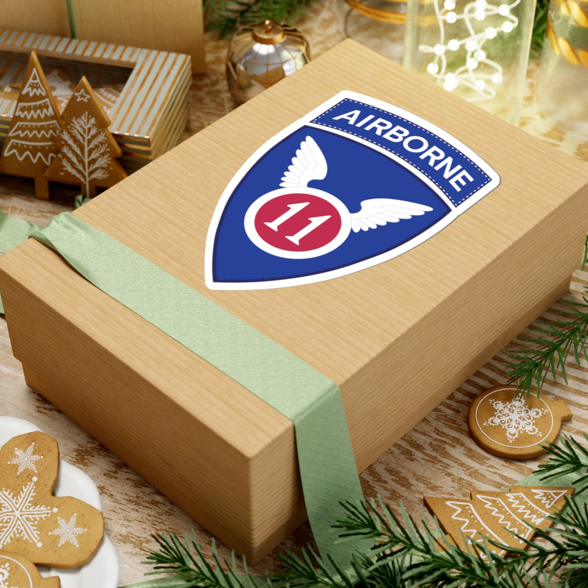 A kiss-Cut Stickers depicting the The 11th Airborne Division, known as the "Angels," is a historic U.S. Army airborne unit. Its shoulder sleeve insignia (SSI) features a red winged sword (symbolizing speed and striking power) on a blue background with a white border.