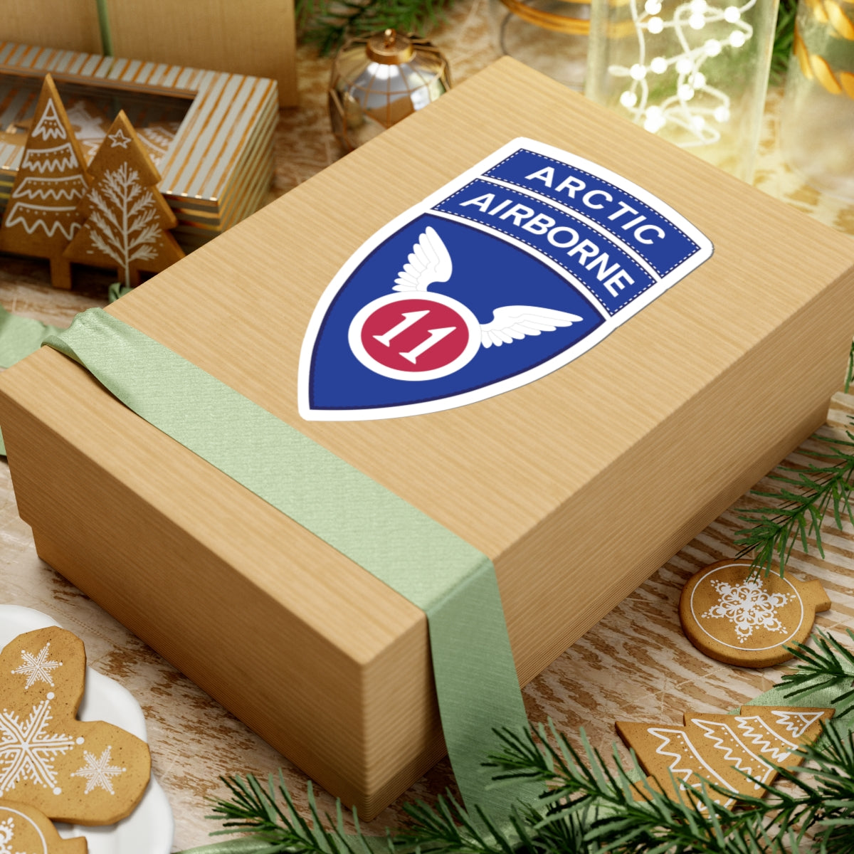 A kiss-Cut Stickers depicting the 11th Airborne Division, reactivated in 2022, is a U.S. Army unit specializing in cold-weather and Arctic operations. Nicknamed the "Arctic Angels," its shoulder sleeve insignia (SSI) features a red angel wing and sword on a blue background, and it is often worn with the "Arctic" tab to denote its mission focus.