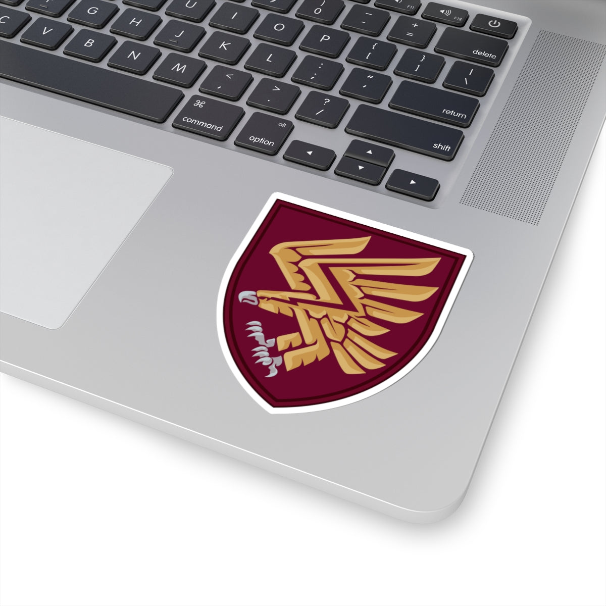 A shield-shaped sticker with a golden eagle design, representing the 95th Air Assault Brigade.
