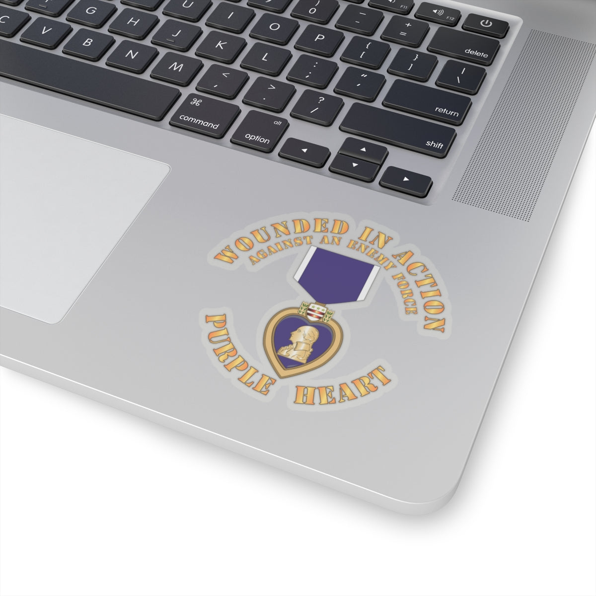 A sticker design featuring the Purple Heart medal with the text 'WOUNDED IN ACTION AGAINST AN ENEMY FORCE' and 'PURPLE HEART'.