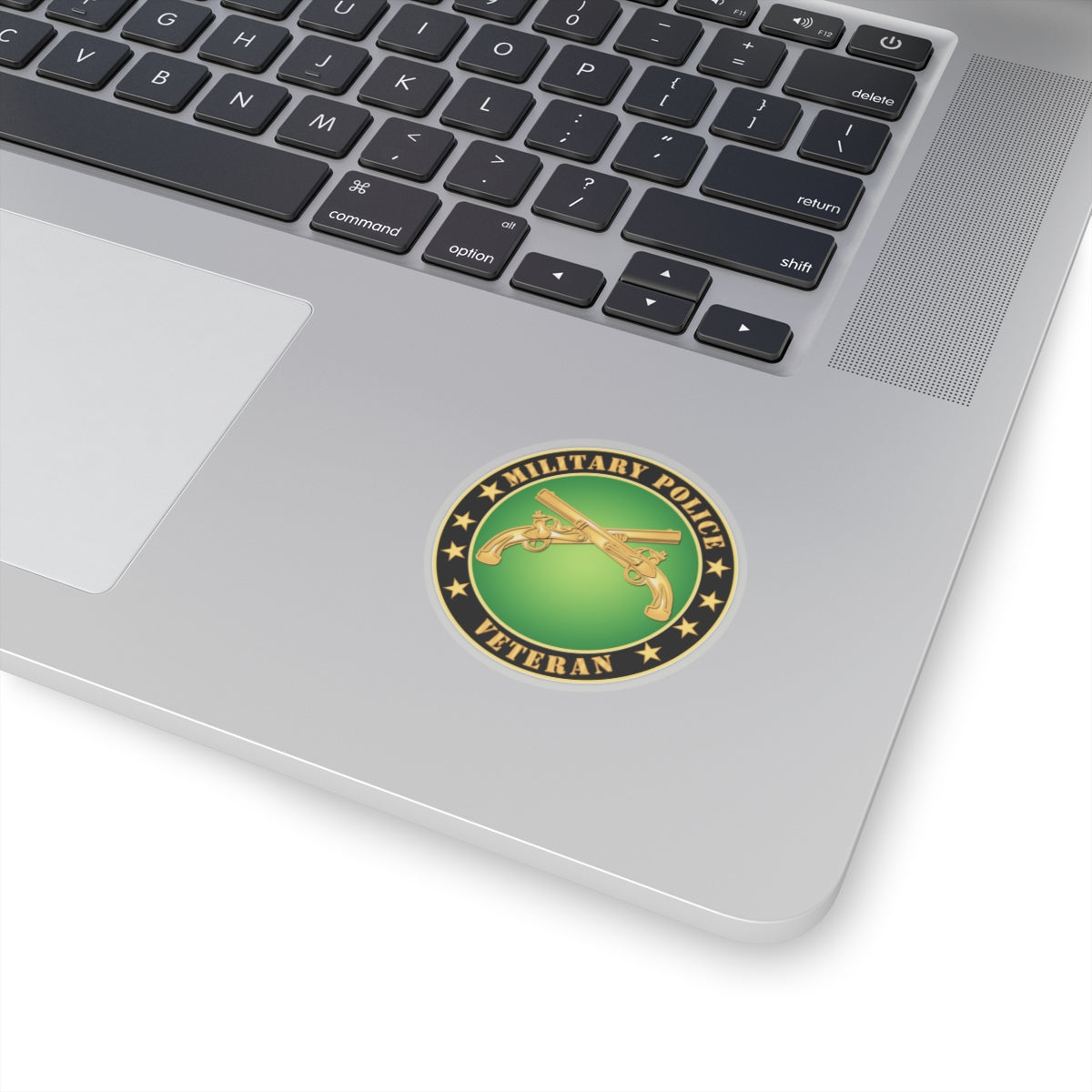 A circular sticker with a green background featuring the text 'MILITARY POLICE VETERAN' and an image of two crossed golden guns with stars around it