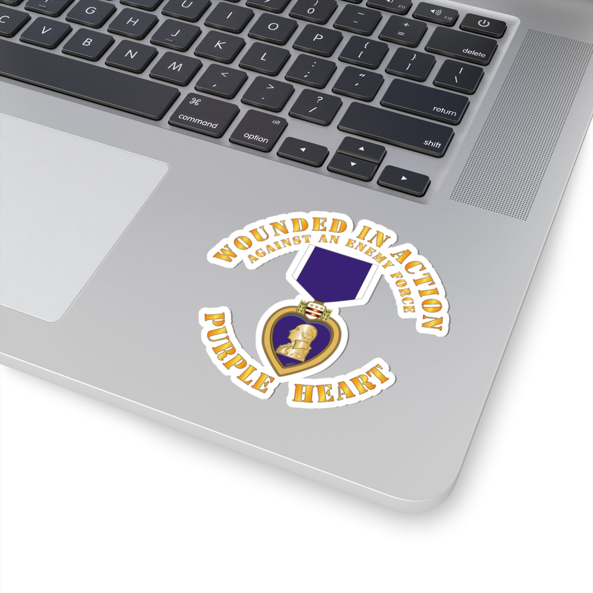 A sticker design featuring the Purple Heart medal with the text 'WOUNDED IN ACTION AGAINST AN ENEMY FORCE' and 'PURPLE HEART'.