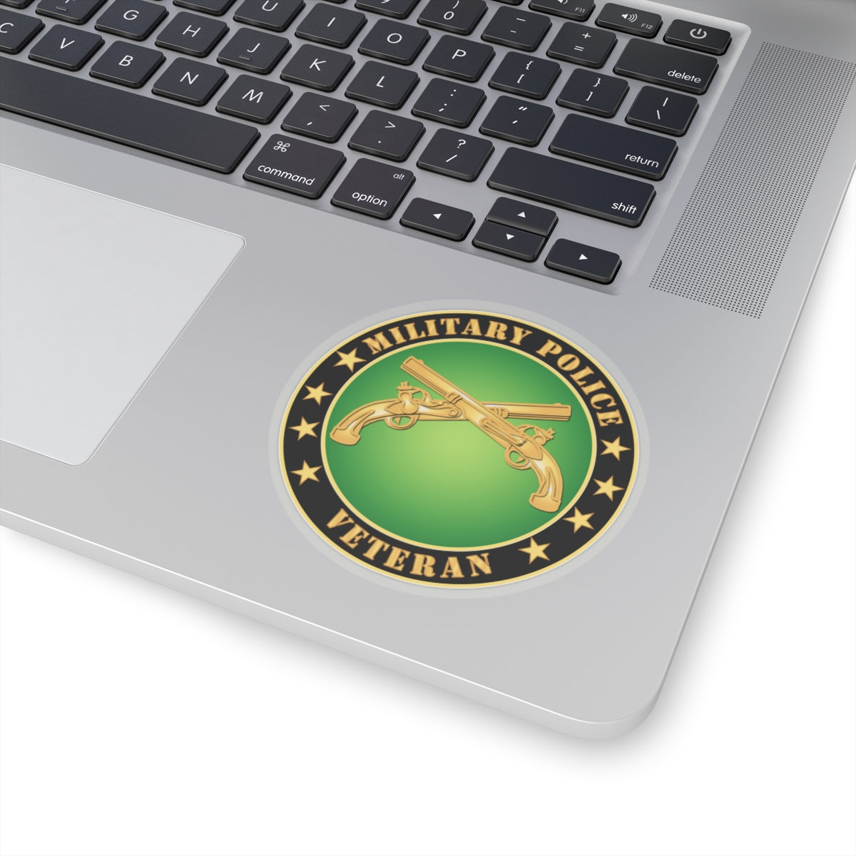 A circular sticker with a green background featuring the text 'MILITARY POLICE VETERAN' and an image of two crossed golden guns with stars around it