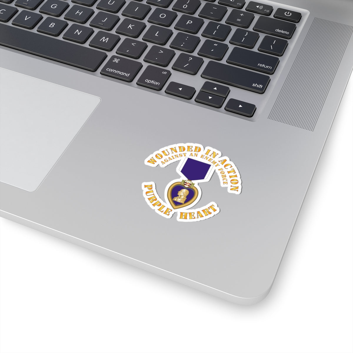A sticker design featuring the Purple Heart medal with the text 'WOUNDED IN ACTION AGAINST AN ENEMY FORCE' and 'PURPLE HEART'.